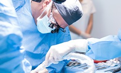 A dentist performing a dental implant surgery