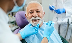 Man smiling at dentist during checkup