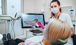 Dentist reviewing scan of patient's teeth