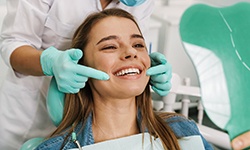 Patient smiling while looking at reflection in mirror