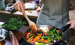 Patient cooking veggies on stovetop