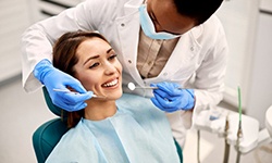 a patient smiling while undergoing a dental visit