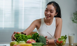 a woman smiling while eating healthy
