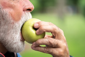 Someone eating an apple