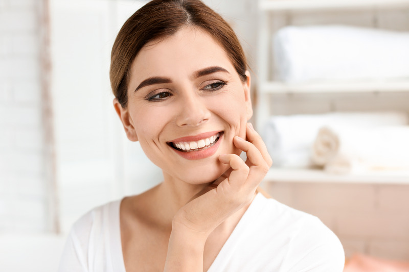 Patient smiling with their new dental implants